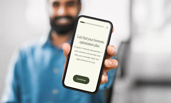 Patient holding phone with Heva intake questionnaire