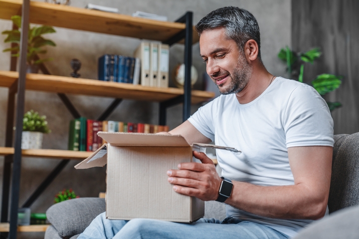 Patient unboxing Heva medication package at home