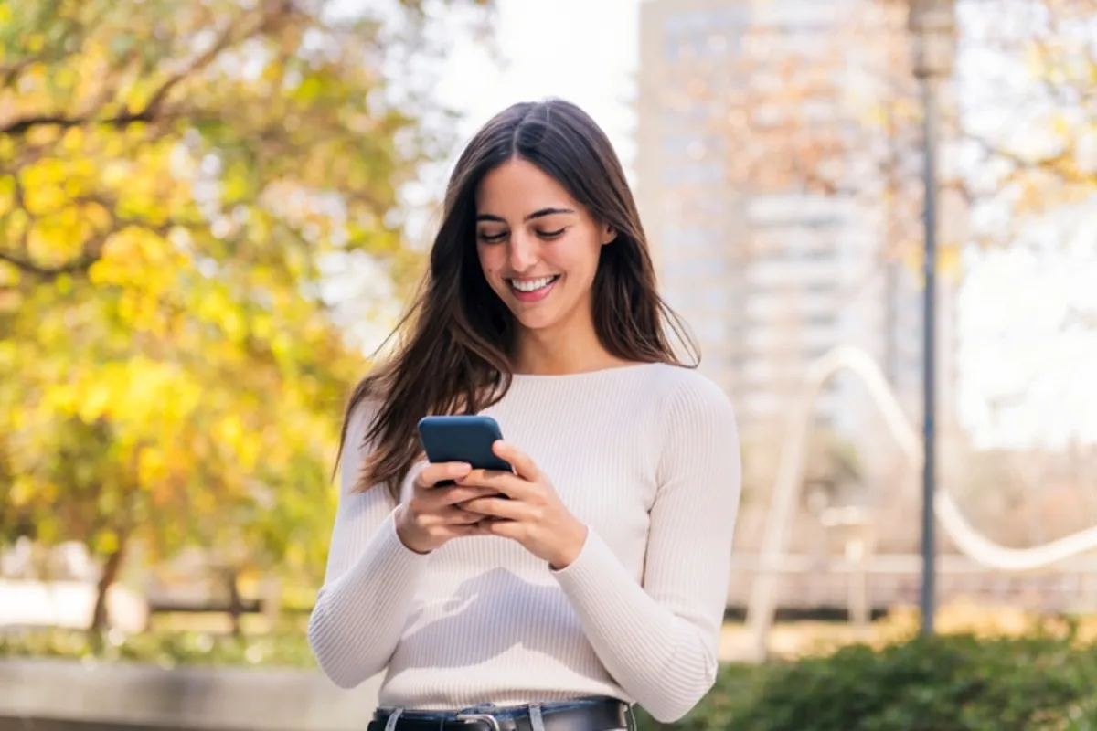 Patient checking her phone on a normal day — no waiting room